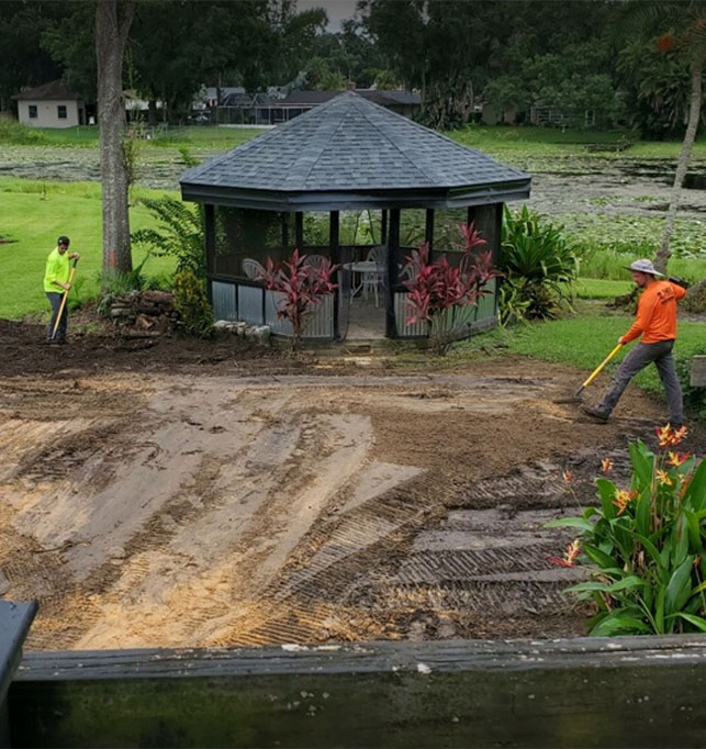 An image of ACE Septic & Waste employees digging in a backyard to put in a septic system.