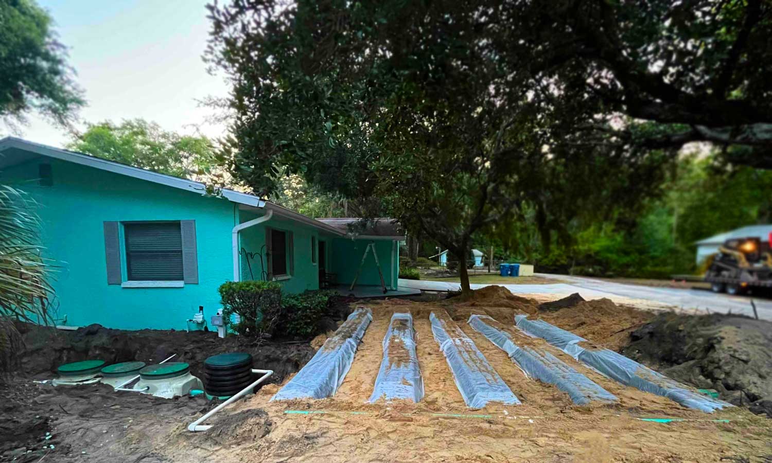 Photograph of a septic drainfield being installed in a front lawn.