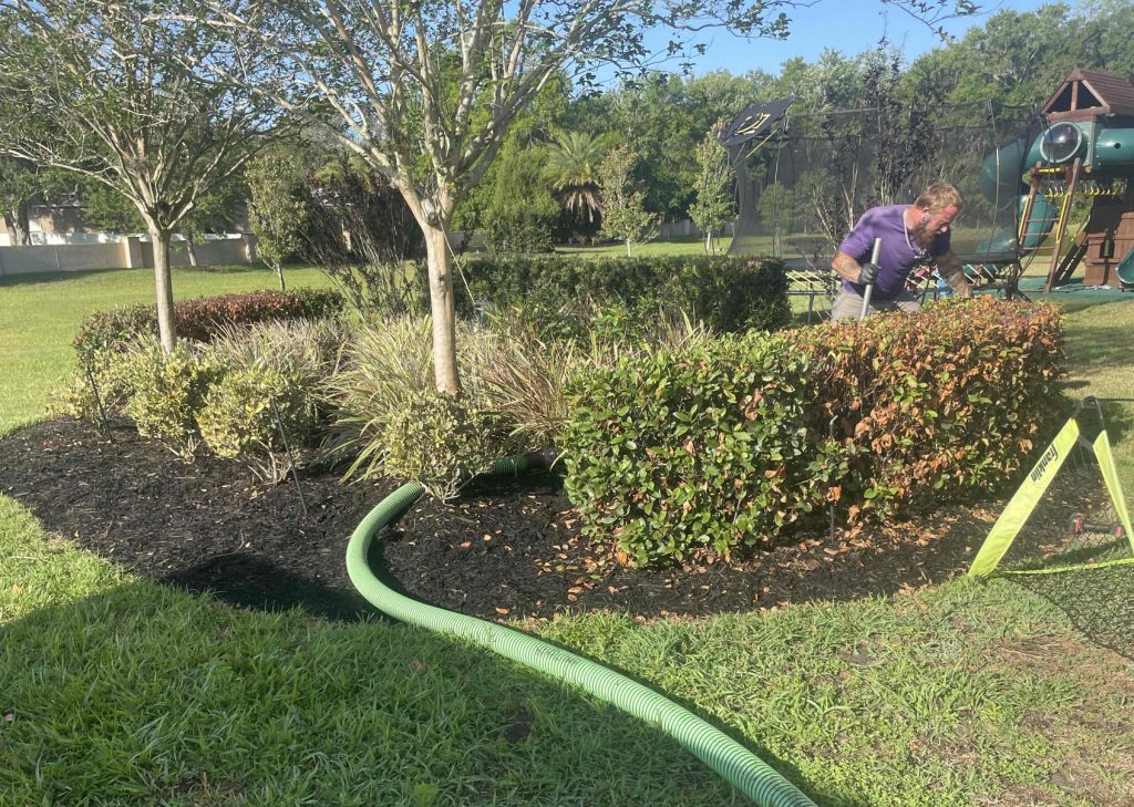 An ACE employee repairs a septic system at a Florida residence.