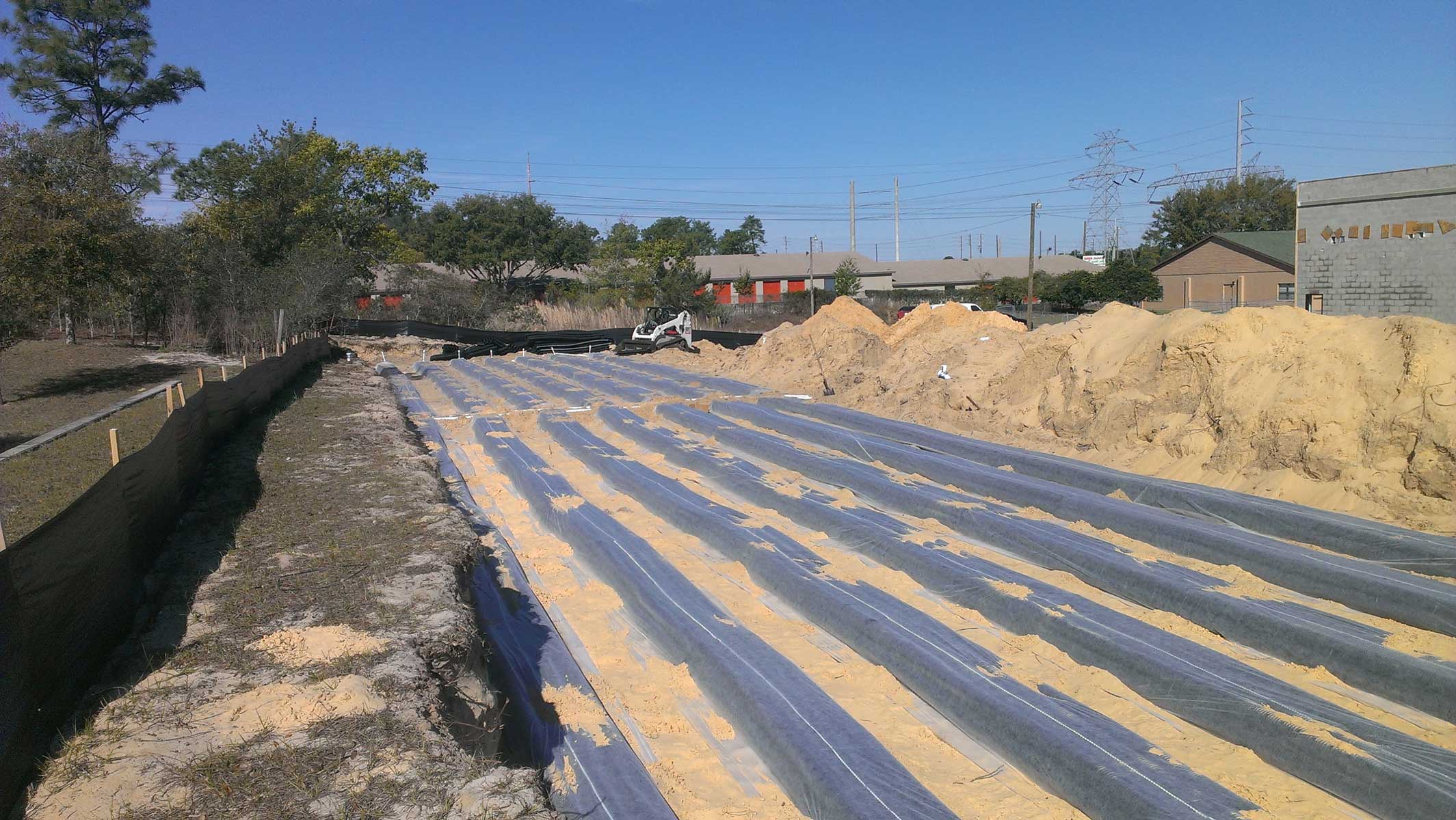 A newly-installed drain field on a sandy filtration layer.