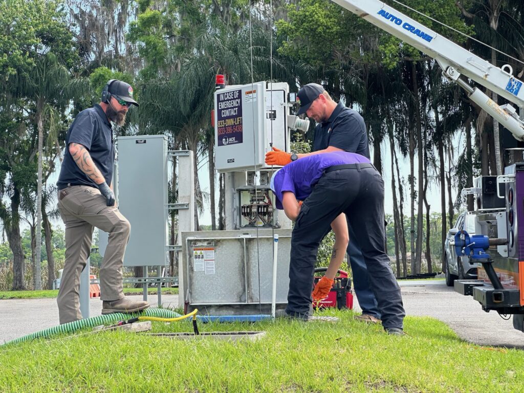 Septic workers performing maintenance on a lift station.