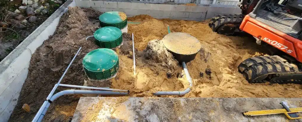 A septic system being installed with septic sand covering it and the surrounding area.